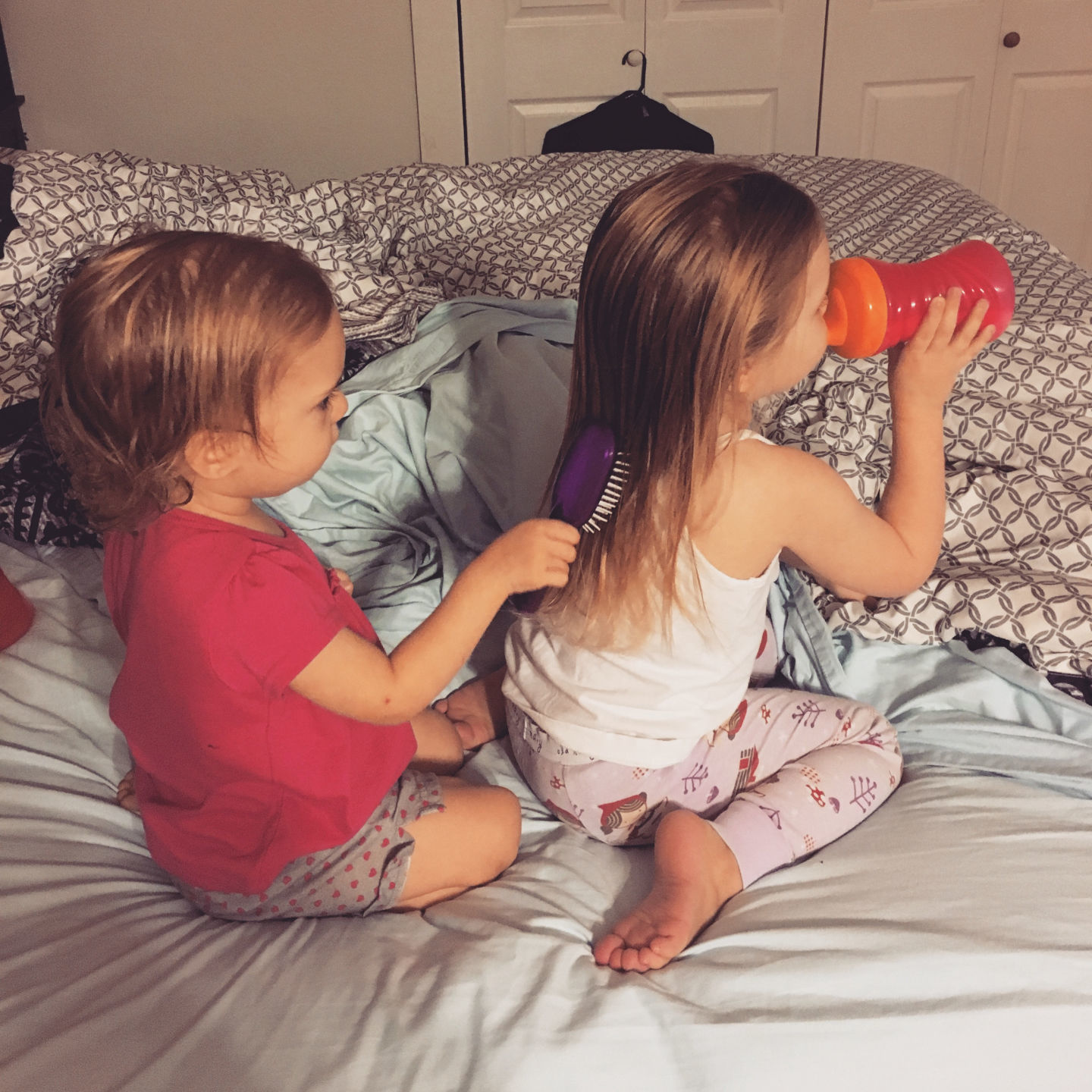 Emily Price brushes her sister Lizzie's hair in the master bedroom of her family's duplex on Gillis W. Long National Guard Center in Carville